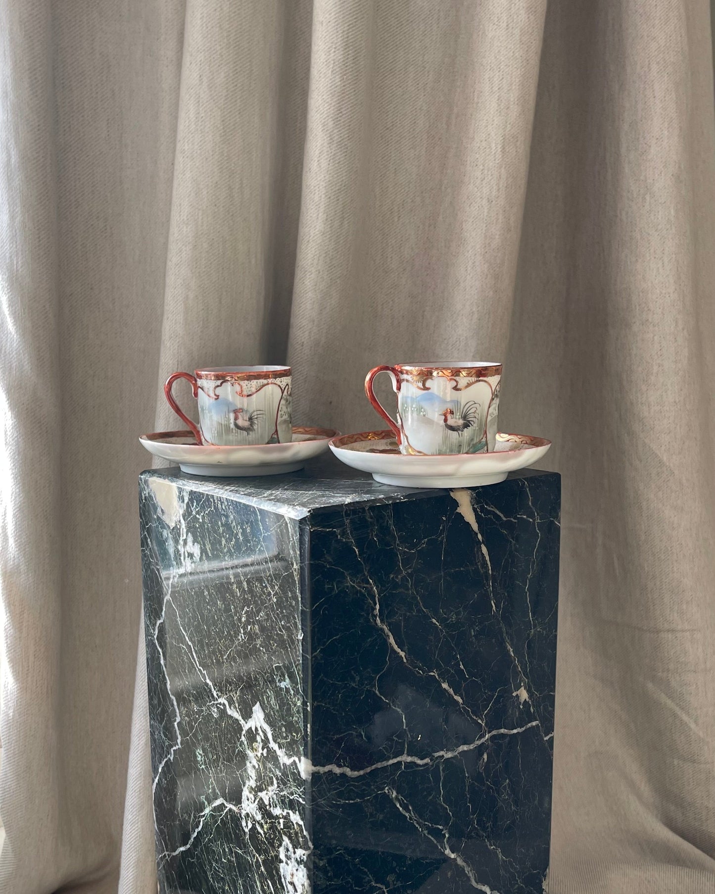 A pair of red Japanese espresso cups and saucers