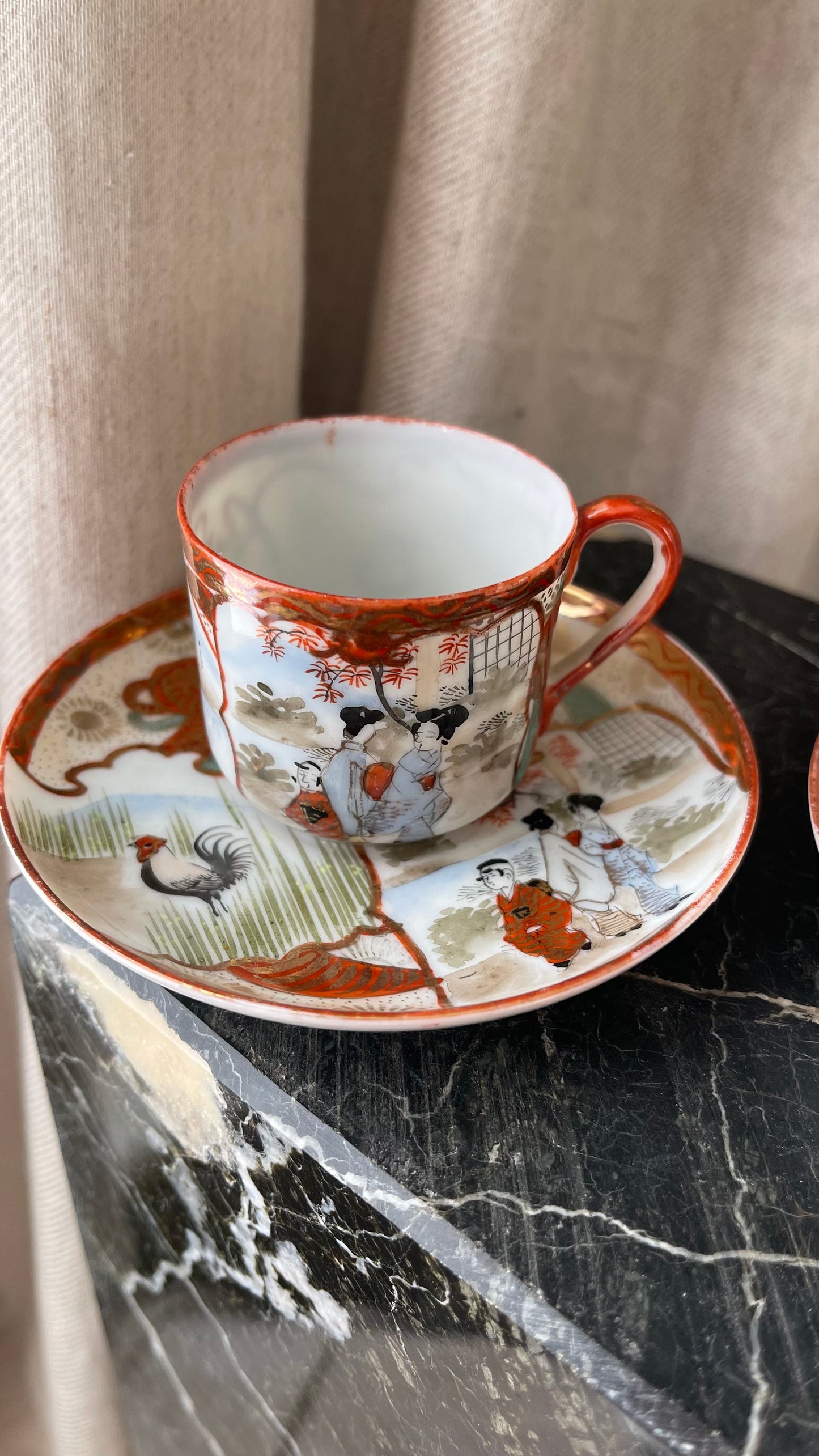 A pair of red Japanese espresso cups and saucers