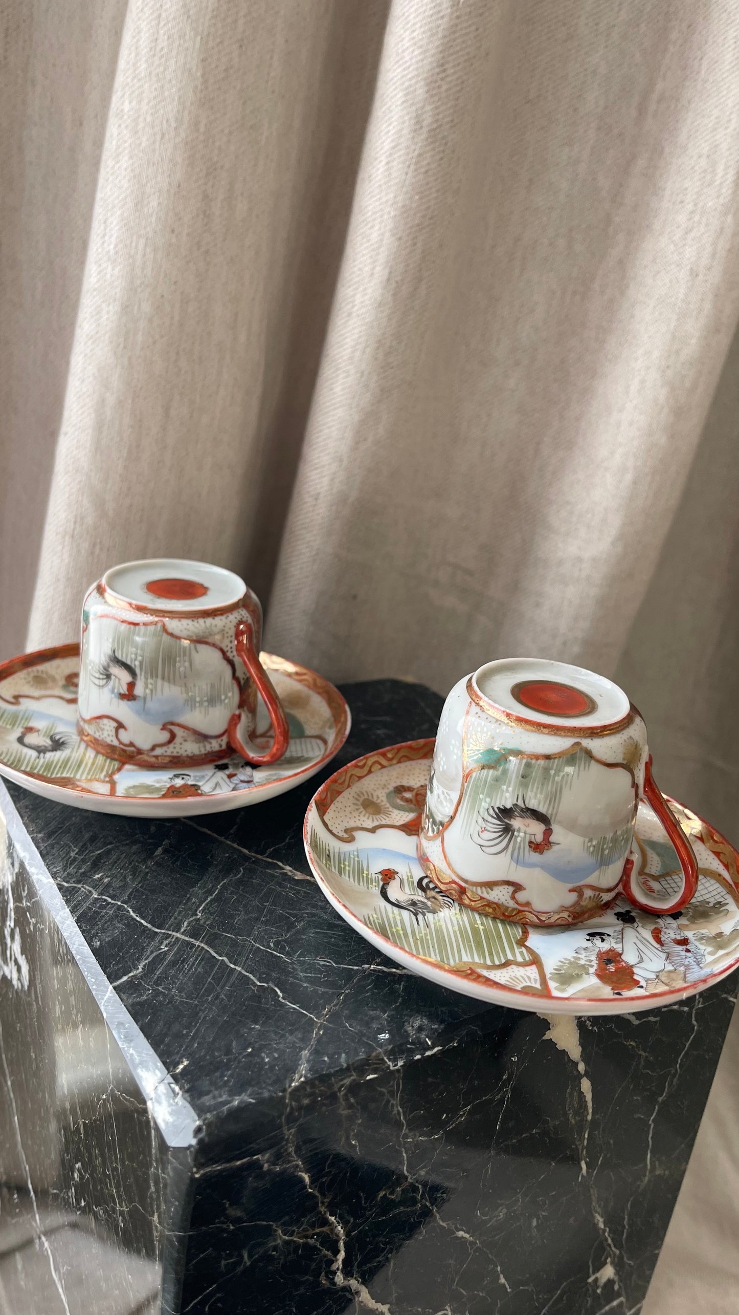 A pair of red Japanese espresso cups and saucers