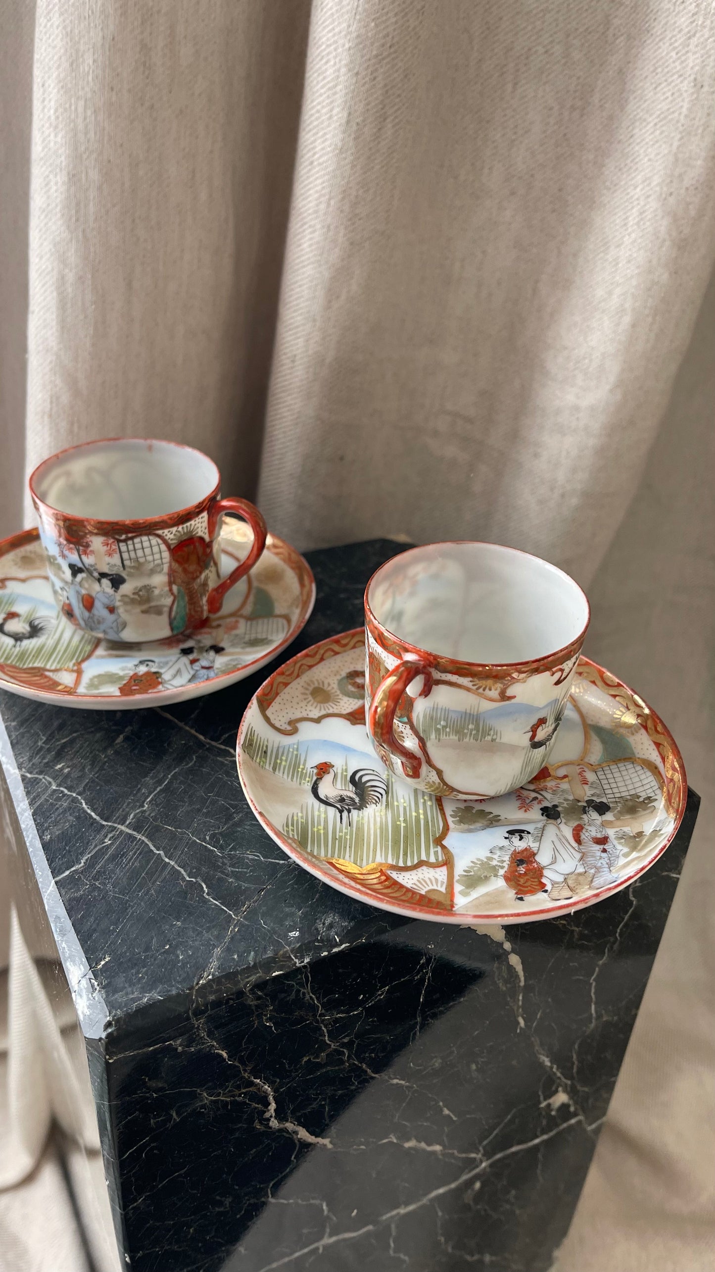 A pair of red Japanese espresso cups and saucers