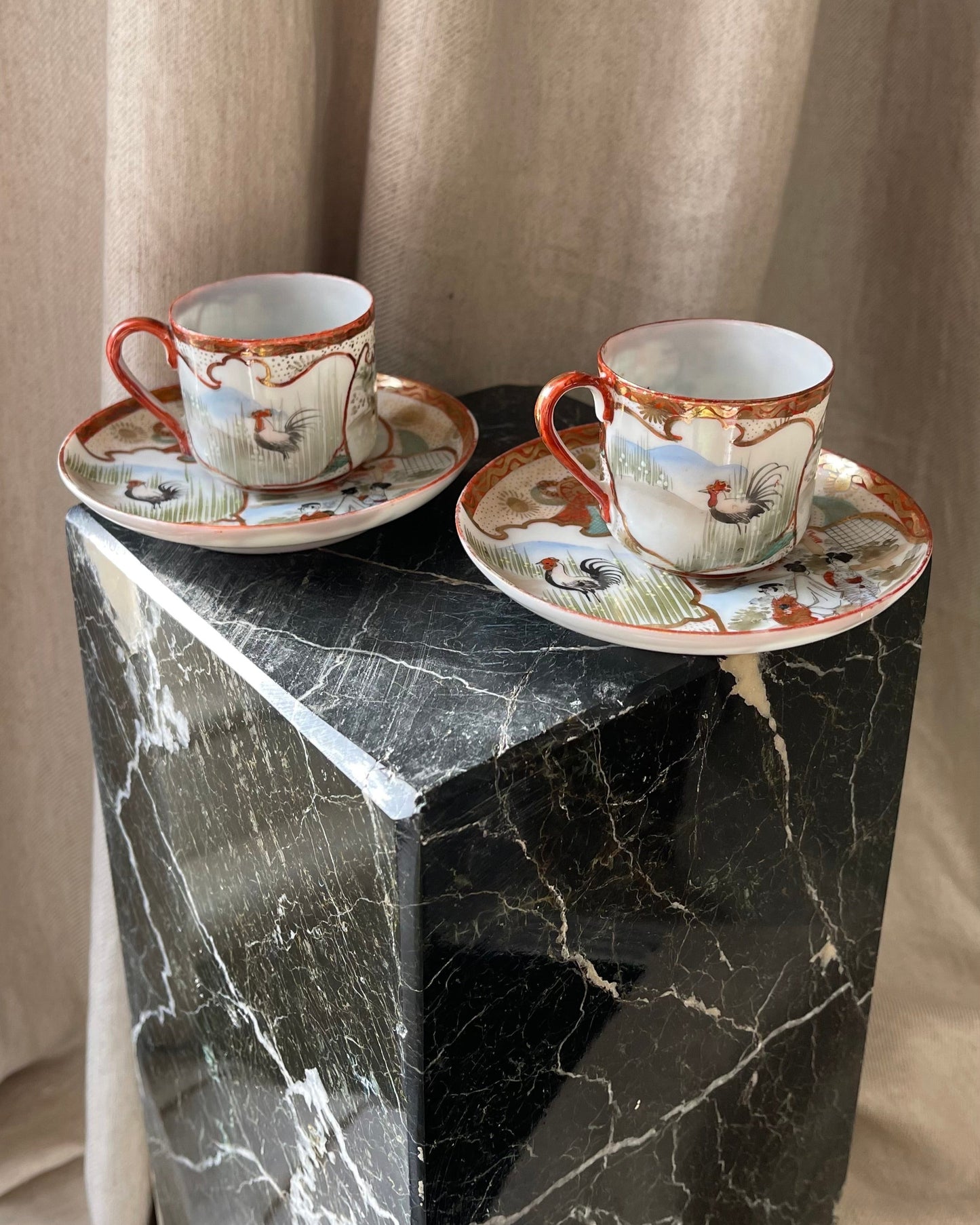 A pair of red Japanese espresso cups and saucers